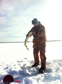 image of ice fisherman catching Pike with a tip up