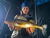 image of Grant Prokop with Walleye in ice shelter