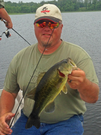 image of Bill Charlton holding Bowstring Lake Bass