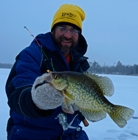 image of Jeff Samsel holding Crappie on the ice
