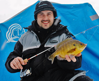image of Blake Liend on the ice holding big Bluegill