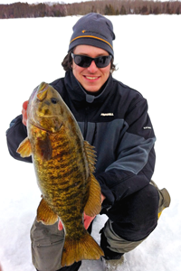image of Nik Dimich holding large Smallmouth Bass