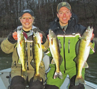 image of Nik Dimich and Becca Kent holding walleyes that they caught near Grand Rapids