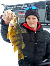image of Dylan with lake winnie perch on ice