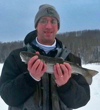 image of Bill Treichel holding Rainbow Trout on ice