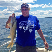 image of Bowen Lodge Guest holding nice Walleye