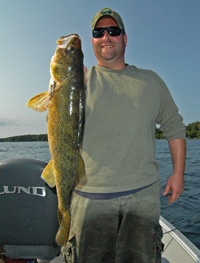 image of Kyle holding a pokegama lake walleye