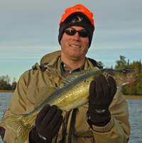 image of Zach Naylor with a nice fall walleye