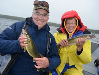 image of Rich and Diane Stribe holding a pair of Walleyes