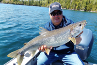 image of Tom Batuik with big lake trout