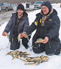 image of Schuttler and Lauber display winning catch of yellow bass