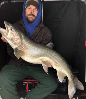 image of Zach Apel with big Lake Trout