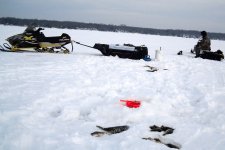 Snowmobile and portable fishing shelter