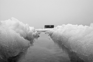 image of ice fishing shelter in standing water