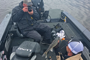 image of photographer taking picture of walleye