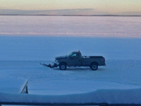 image of truck plowing snow on Bowstring Lake
