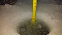 image of ruler showing thickness of freshly drilled ice 