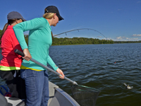 Brooke and Kristin Hastings landing a fish