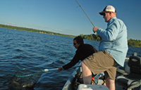 image of Glenn and Jen Fraze netting Pokegama Lake Walleye