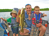 image of Johnny holding noce walleye and giving thumbs up