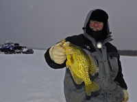 image of Bill Powell holding big Crappie on the ice