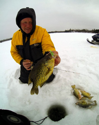 image of fishing pro Jeff Sundin with slab Crappie on ice