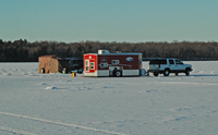 image of truck and large ice fishing shelter on Bowstring Lake
