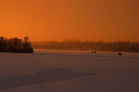 image of ice fishing shelters at sunset