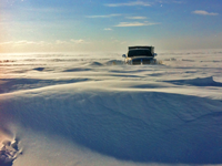 image of pickup truck stuck in deep snow on the ice