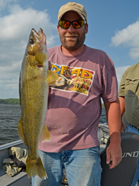 image of Chris Andresen with a large walleye caught on Pokegama Lake