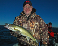 image of Matt Nistler holding Leech Lake Walleye in morning