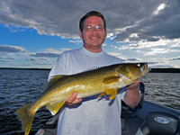 image of Jesse Gotchie hold a big walleye from pokegama lake
