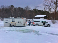 image of truck and fishing shelter stuck on the ice