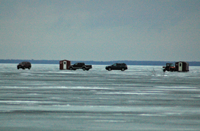image of pickup trucks on the ice at Lake Winnie