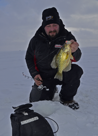 image of Zach Dagel holding Crappie on ice