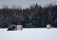 image of fishing shelters and ATV on ice