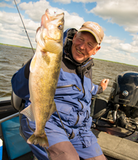 image of fishing guide holding big walleye