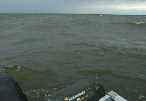image of big waves behind boat
