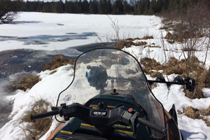 image of snowmobile on remote lake