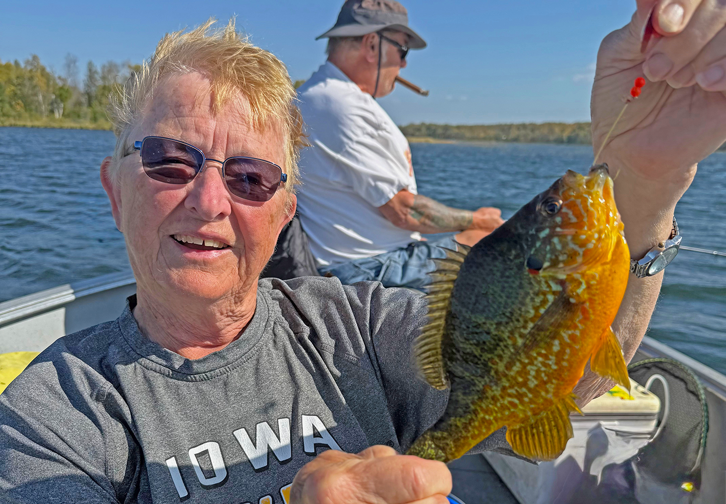 image of Karen Reynolds showing off a big pumpkinseed sunfish