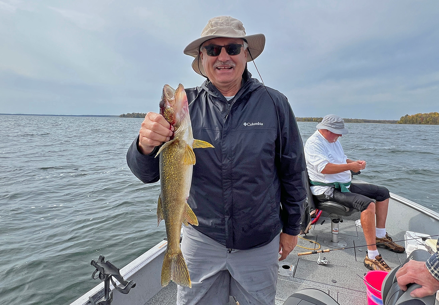 image of Tim Fischbach with lake Winnie Walleye