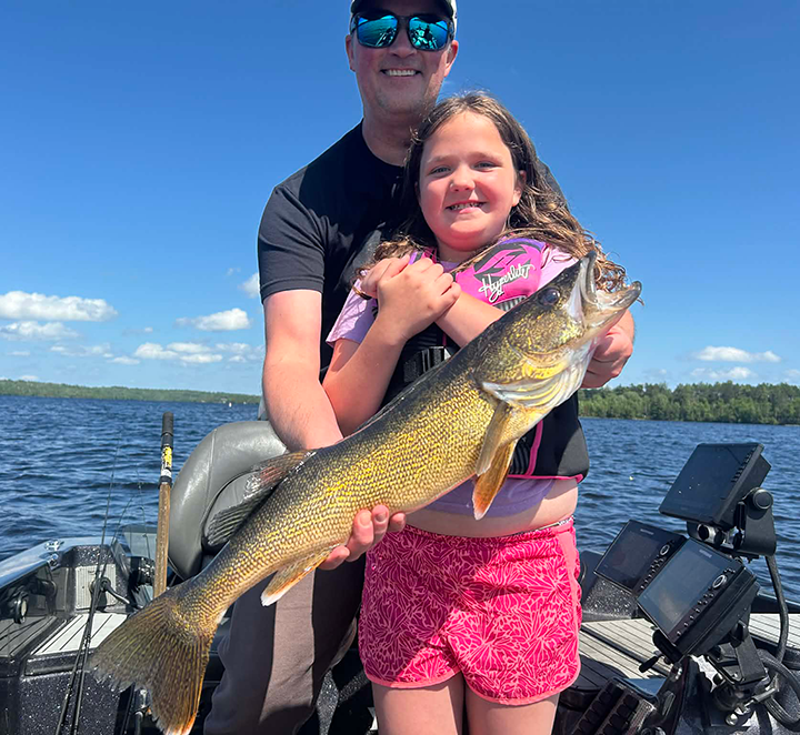 image of father and daughter holding big walleye caught on Lake Vermilion with Justin Chromy